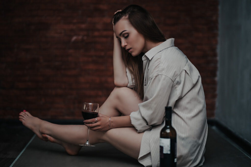 beautiful sad woman sitting on floor in shirt hol 2023 11 27 05 22 12 utc Early signs of addiction in women Early signs of addiction in women,spotting addiction signs,women's addiction symptoms