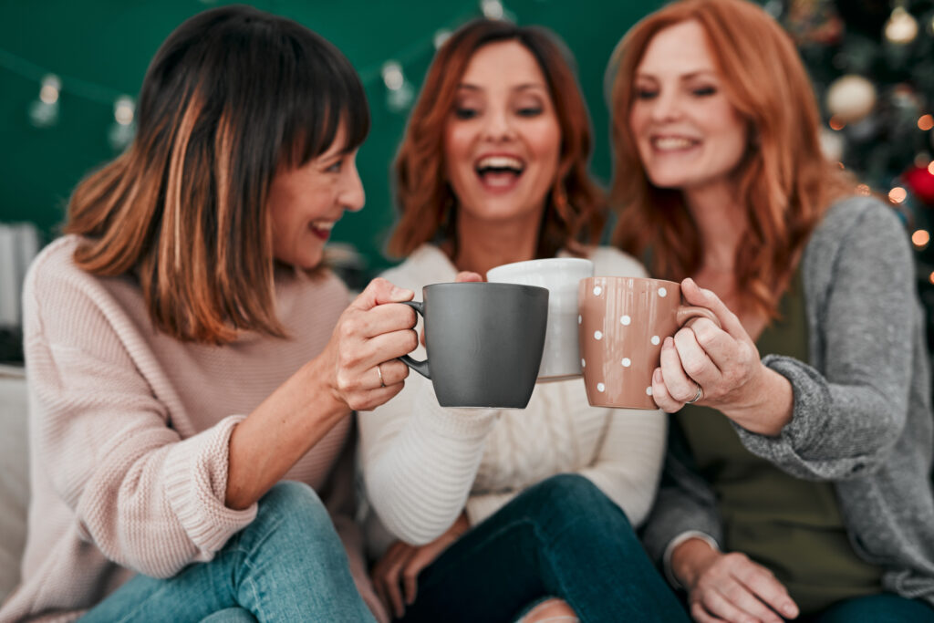 A group of women enjoying coffee and tea together, choosing connection and relaxation over wine mom culture.
